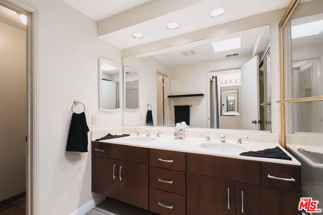 a en suite bathroom with a sink and mirror