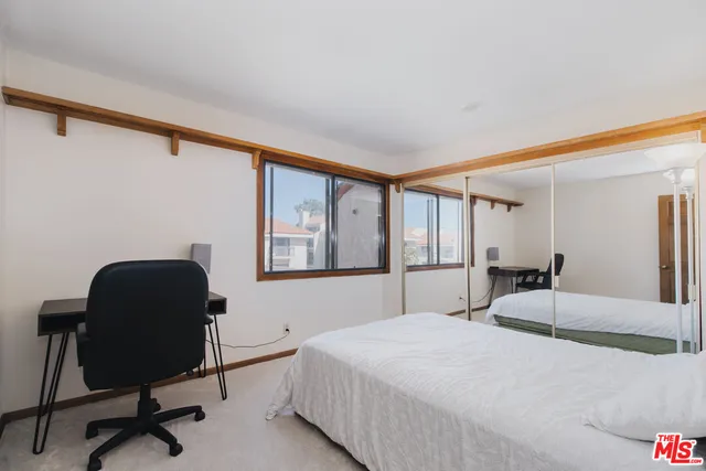 a bedroom with a bed and a chair