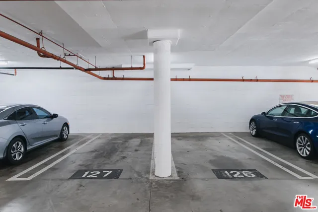 a front view of a building with outdoor seating and a yard