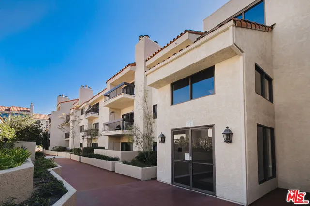 a very nice looking living room with a large window and dining table