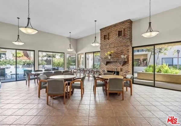 a very nice looking living room with a large window and dining table