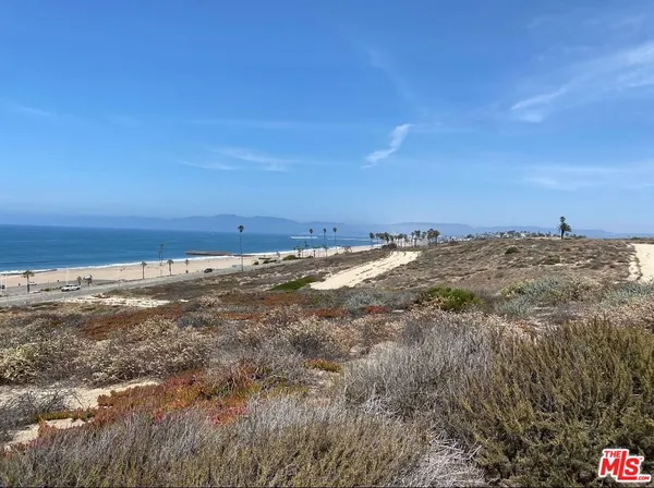 a view of a ocean with a building in the background