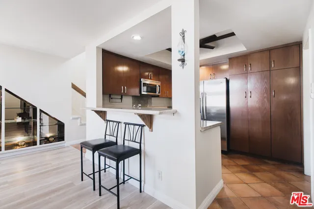 a view of kitchen with furniture and wooden floor