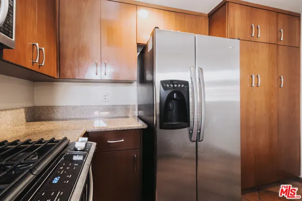 a kitchen with a refrigerator and a sink