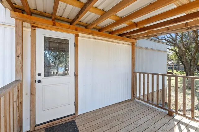 a view of a balcony with wooden floor