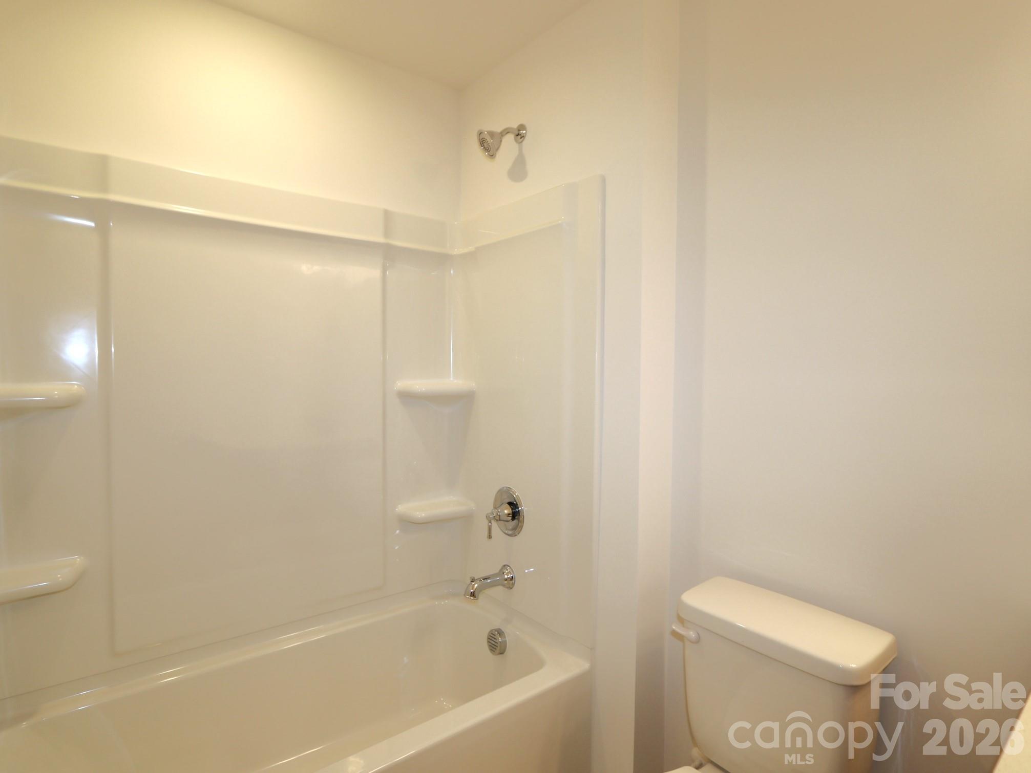 1110 Overbrook Place Wingate, NC 28174 - Photo 14 of 21 a bathroom with a bathtub and a toilet