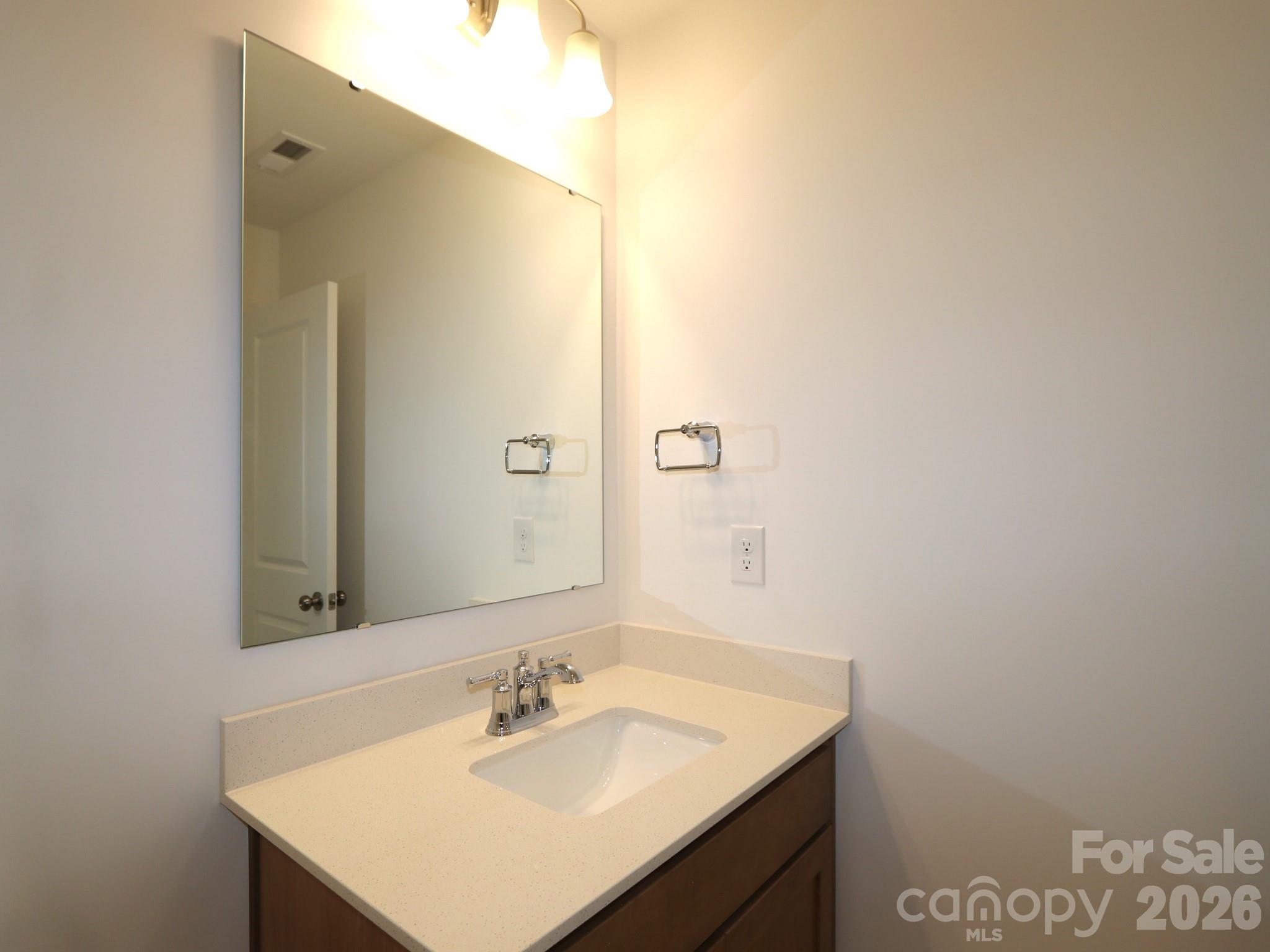 1110 Overbrook Place Wingate, NC 28174 - Photo 15 of 21 a bathroom with a sink and a mirror