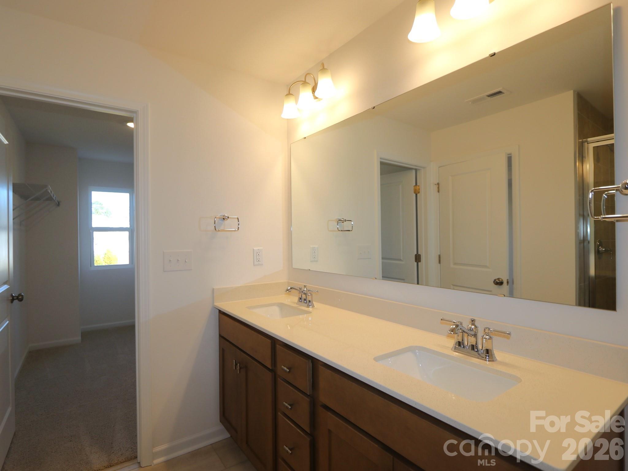 1110 Overbrook Place Wingate, NC 28174 - Photo 19 of 21 a bathroom with a sink and a mirror