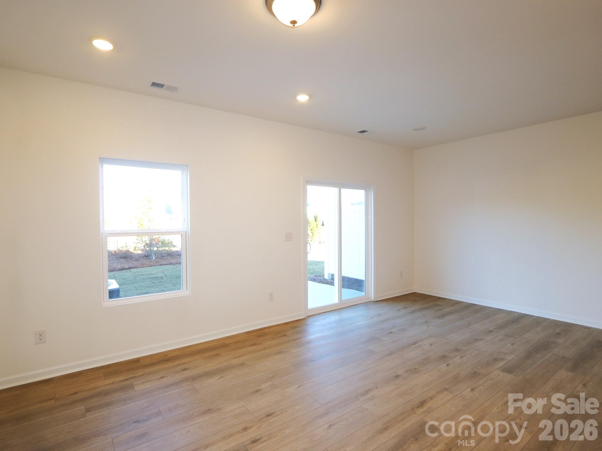 1110 Overbrook Place Wingate, NC 28174 - Photo 8 of 21 an empty room with wooden floor and windows