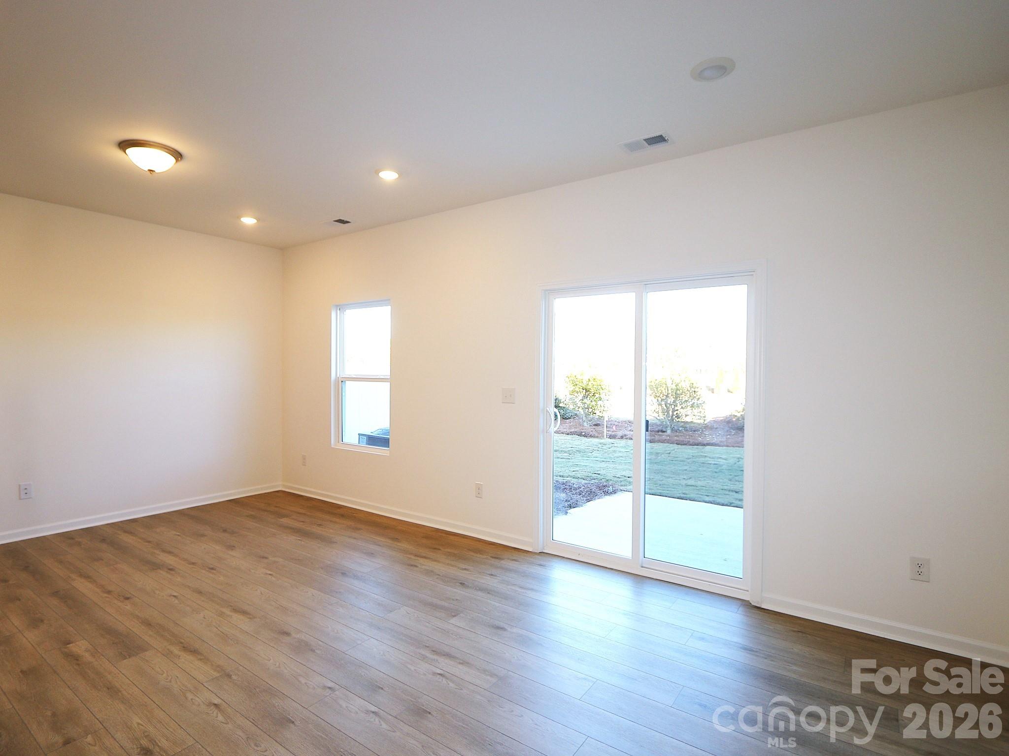 1110 Overbrook Place Wingate, NC 28174 - Photo 9 of 21 an empty room with wooden floor and windows
