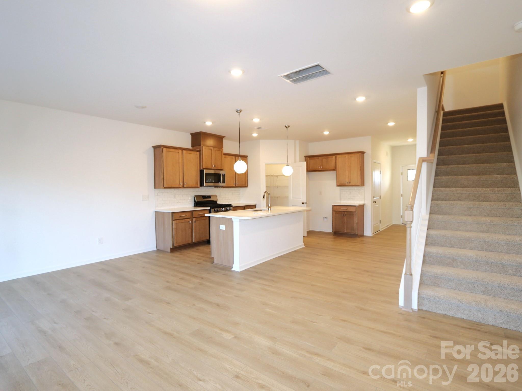 1110 Overbrook Place Wingate, NC 28174 - Photo 10 of 21 a view of kitchen with kitchen island stainless steel appliances counter top space