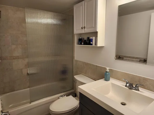 a bathroom with a sink toilet and shower