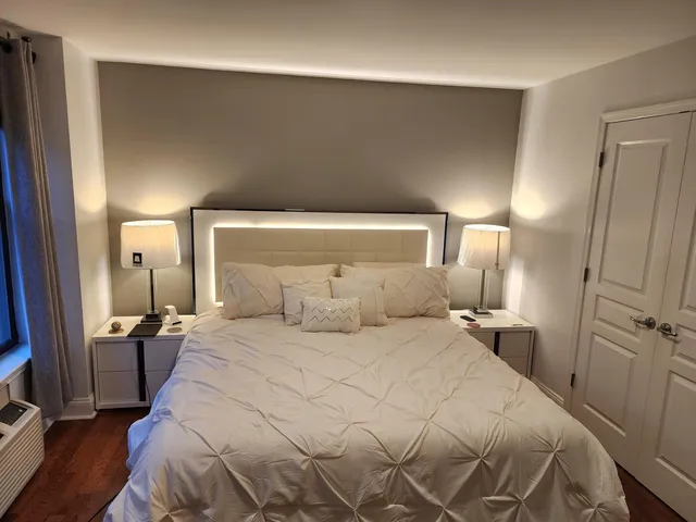 a bedroom with a bed and a mirror