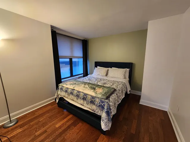 a bed sitting in a bedroom next to a window