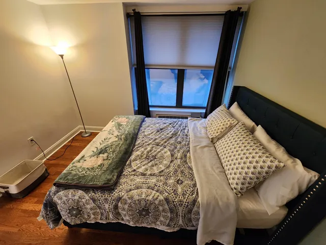 a bedroom with a bed and a window