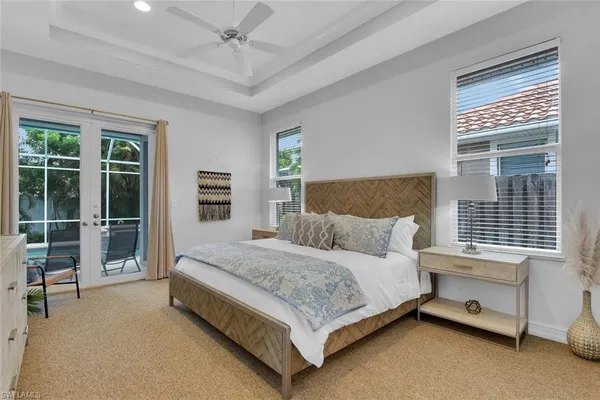 a bedroom with a bed and a dresser next to a window