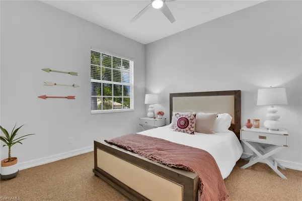 a bedroom with a bed and a potted plant