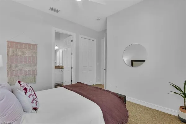 a bedroom with a bed and a mirror