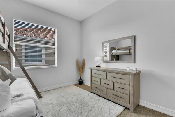 a room with a bed and a dresser