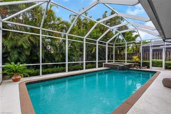 a view of a backyard with swimming pool