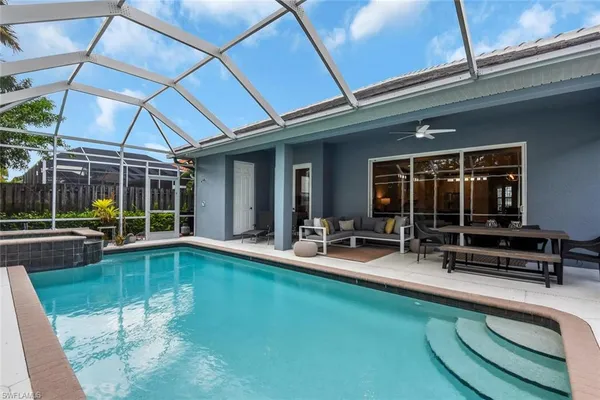 a view of a patio with table and chairs under an umbrella
