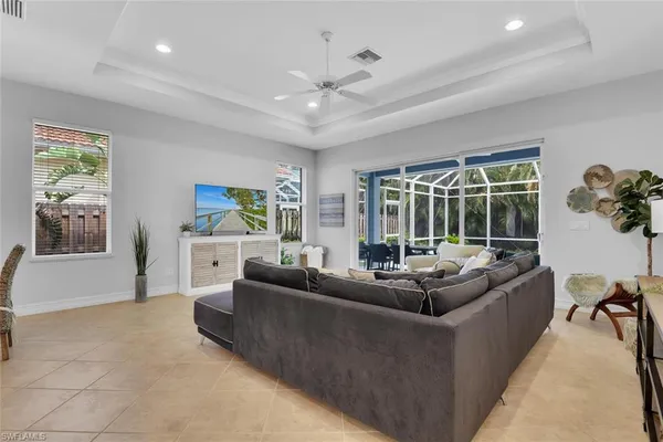 a living room with furniture and large windows