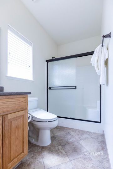 409 Acacia Street Ridgecrest, CA 93555 - Photo 22 of 34 a bathroom with a toilet and a shower