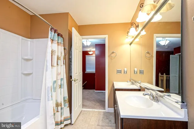 a en suite bathroom with a sink a mirror and a shower