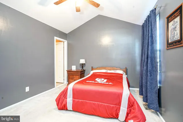 a bedroom with a bed and a night stand