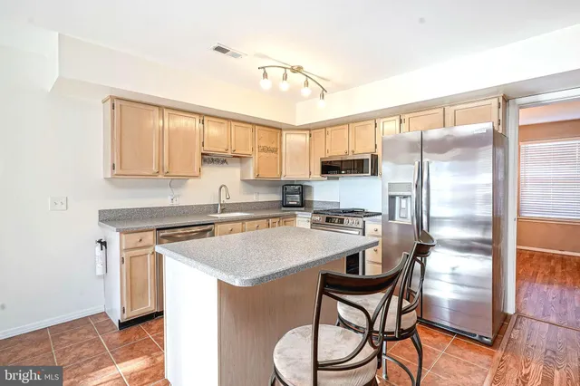a kitchen with a stove a sink and a refrigerator