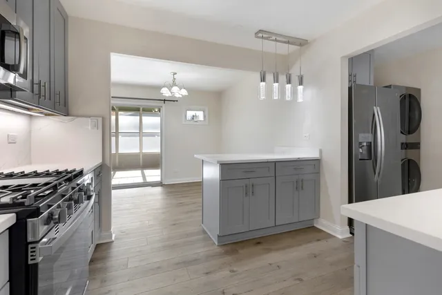 a kitchen with a sink and a stove top oven