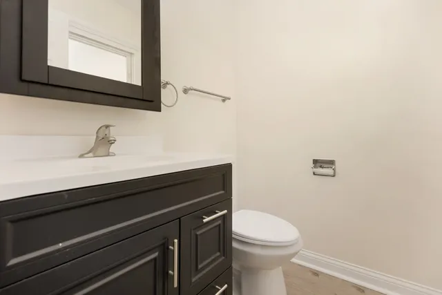 a bathroom with a sink a toilet and mirror