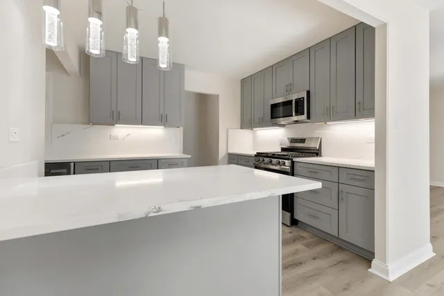 a kitchen with a sink cabinets and stainless steel appliances