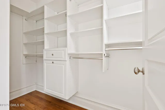 a view of walk in closet with empty racks