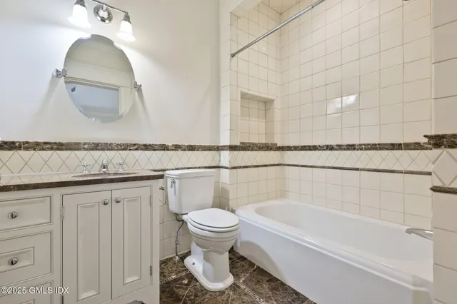a bathroom with a toilet a sink and bathtub