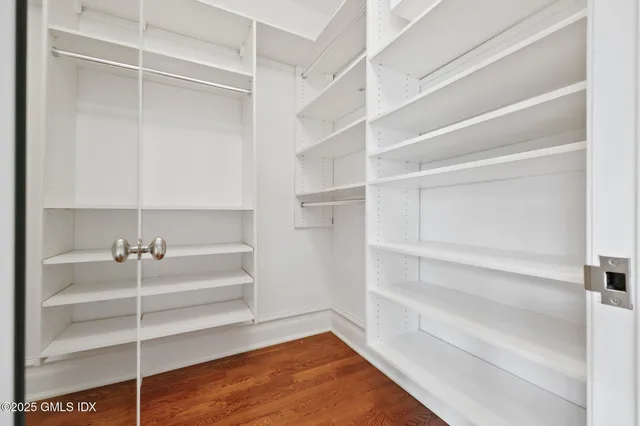 a view of walk in closet with empty racks