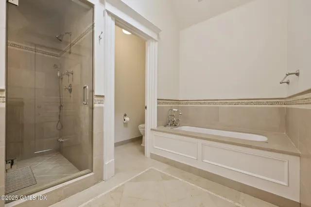 a spacious bathroom with a bathtub and a shower