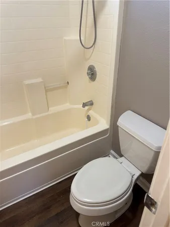 a bathroom with a toilet and a bath tub