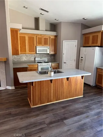 a kitchen with wooden floors wooden cabinets and sink