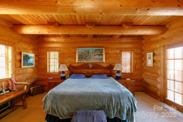 a bathroom with a granite countertop double vanity sink a mirror and a bathtub