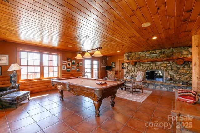 a bedroom with two beds and large windows