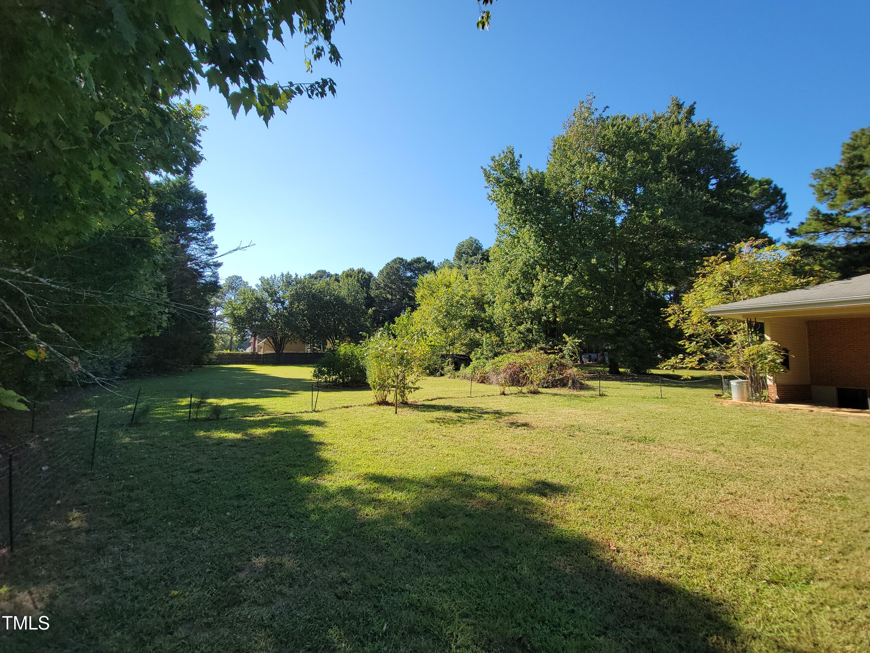 7000 Holly Springs Road Raleigh, NC 27606 - Photo 23 of 24 a view of a swimming pool with an outdoor space and seating area