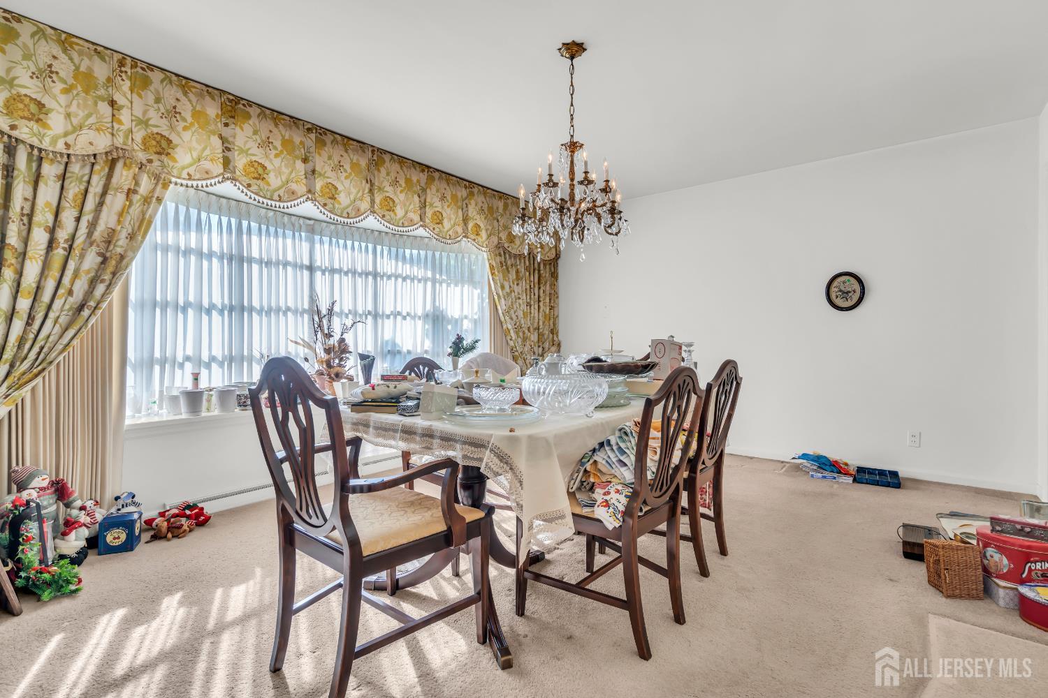 16 Stafford Road Colonia, NJ 07067 - Photo 11 of 41 a view of a dining room with furniture and chandelier