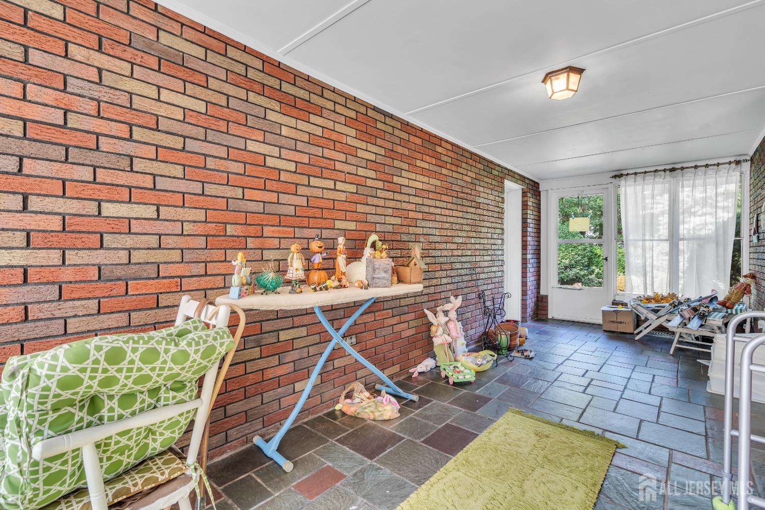 16 Stafford Road Colonia, NJ 07067 - Photo 21 of 41 a patio with table and chairs and potted plants
