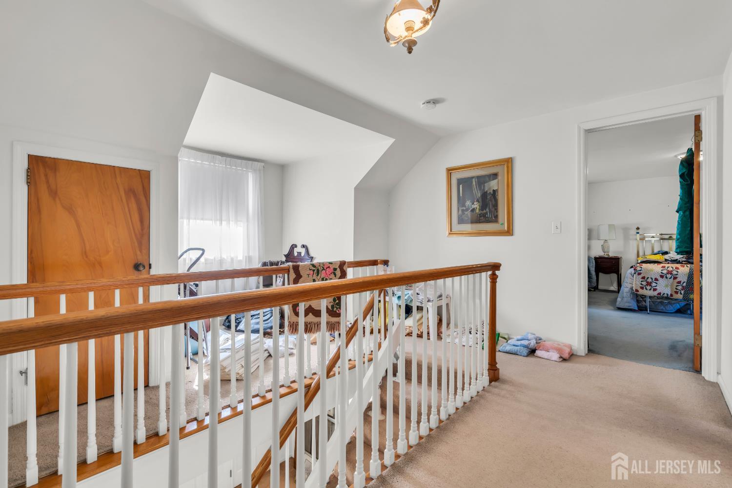 16 Stafford Road Colonia, NJ 07067 - Photo 24 of 41 a view of a hallway with wooden floor and stairs