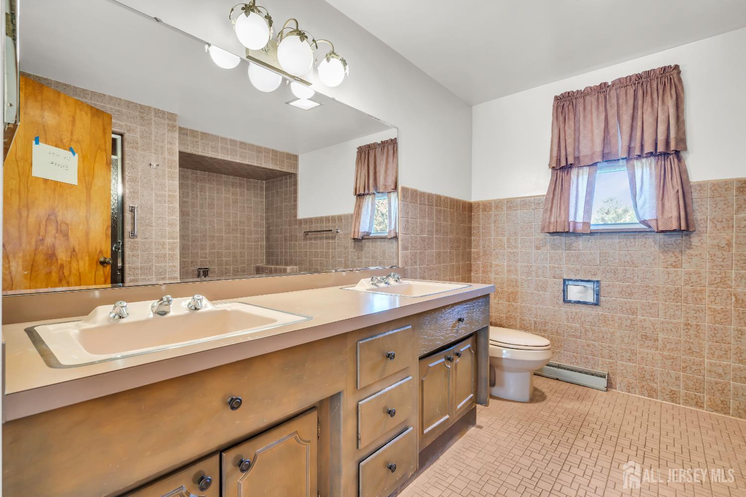 16 Stafford Road Colonia, NJ 07067 - Photo 25 of 41 a bathroom with a sink a toilet and a mirror