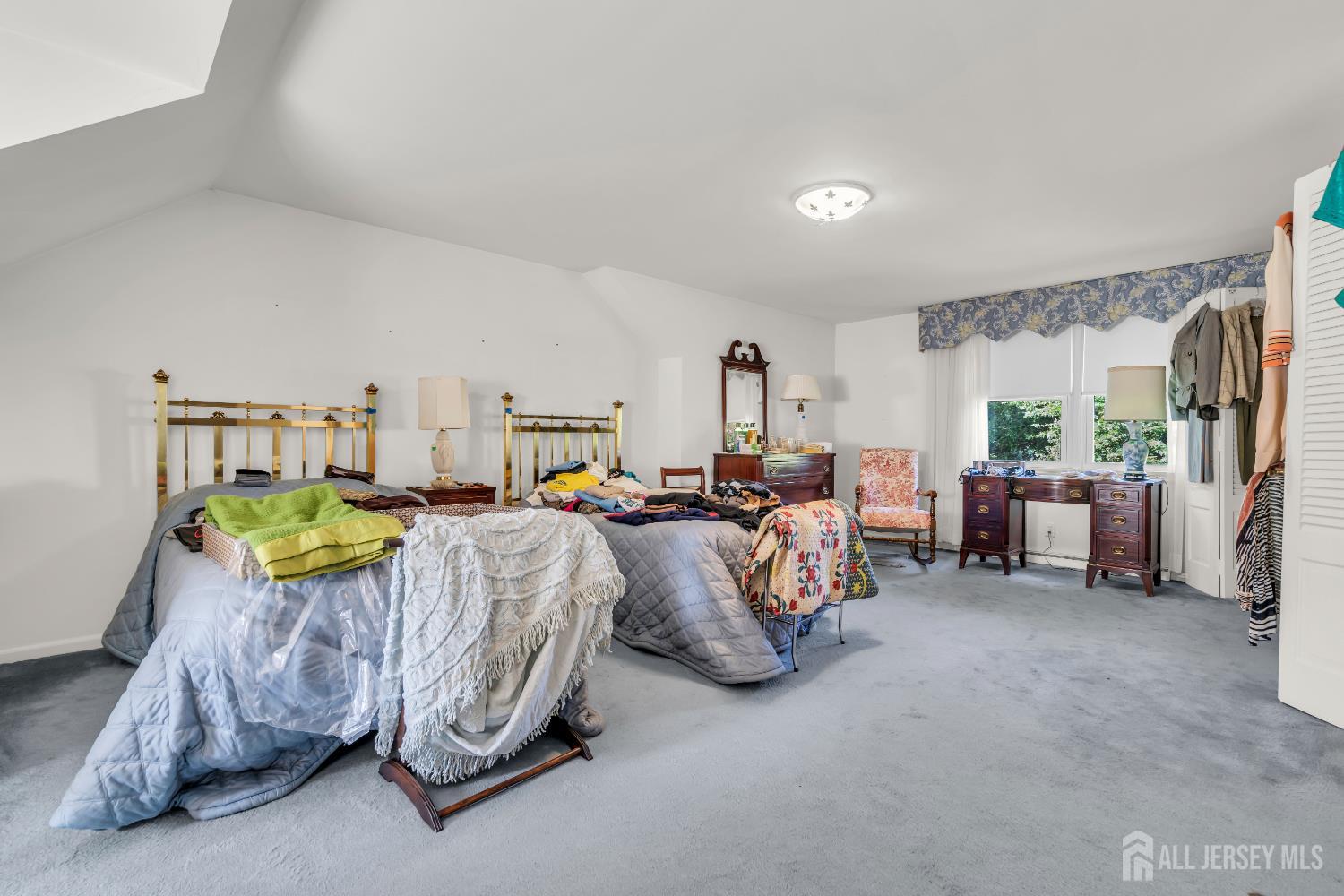 16 Stafford Road Colonia, NJ 07067 - Photo 30 of 41 a spacious bedroom with a bed and a chandelier