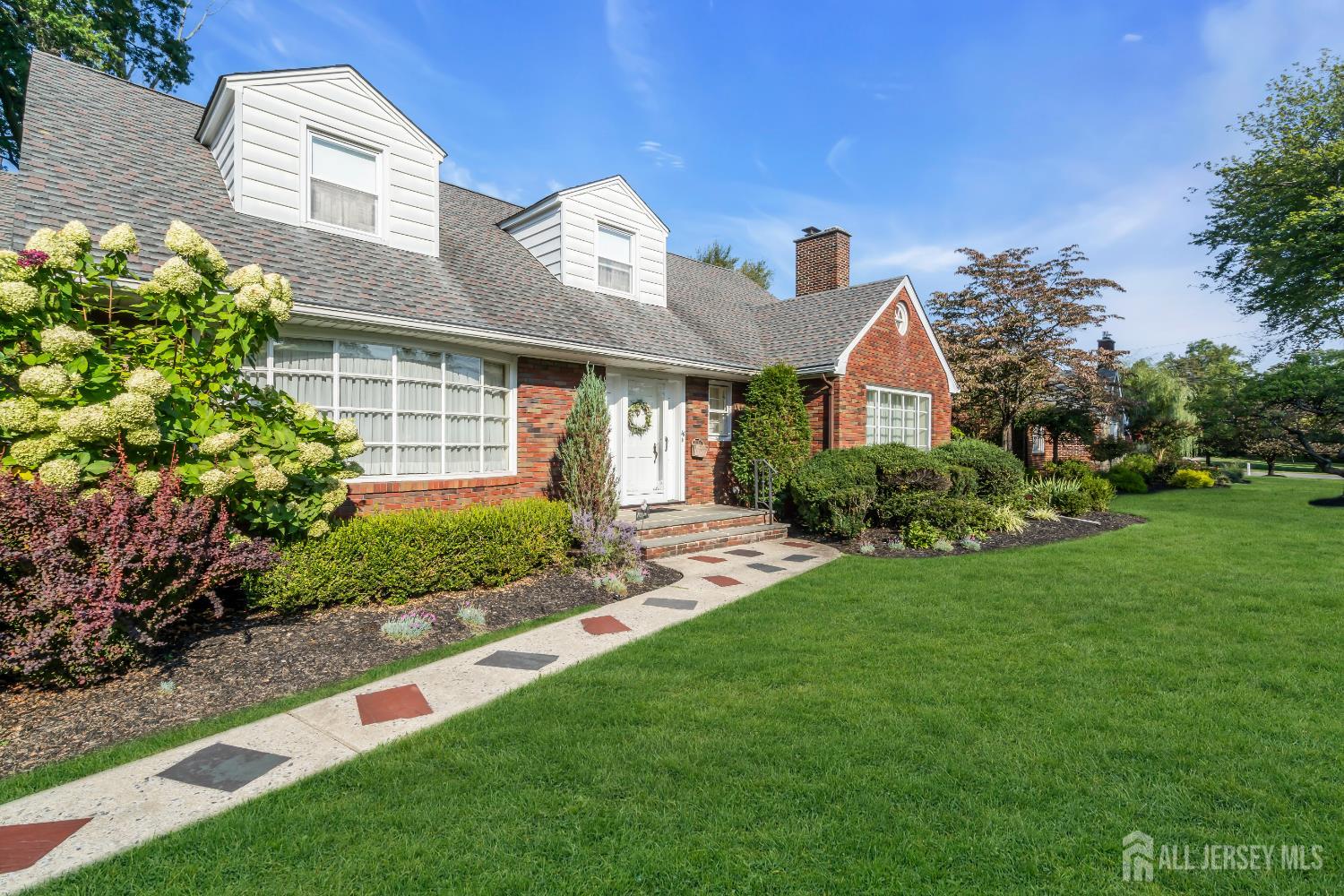 16 Stafford Road Colonia, NJ 07067 - Photo 4 of 41 a front view of a house with a garden and plants