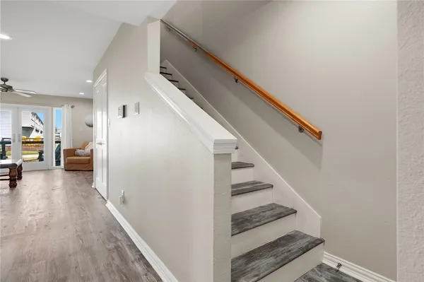 a view of entryway and hall with wooden floor