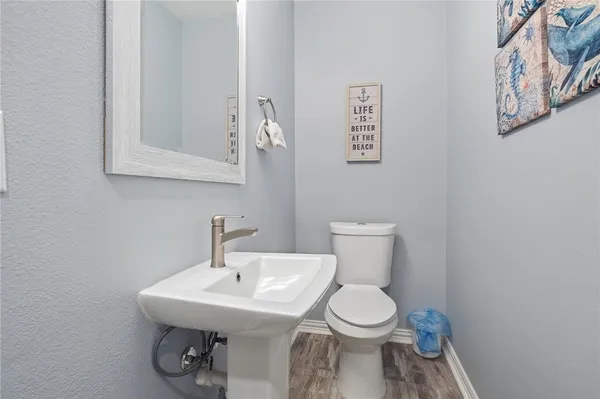 a bathroom with a toilet a sink and mirror